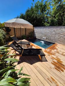a deck with two chairs and a swimming pool at Le Cocoon - Jacuzzi, Sauna et Piscine privée in Carpentras