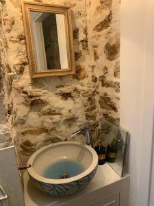 a bathroom with a sink and a mirror on a counter at Amor Fati in Amfilochia +9 photos