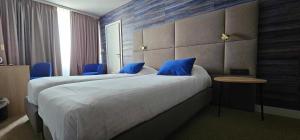 Voodi või voodid majutusasutuse Hotel Les 3 Cles toas
