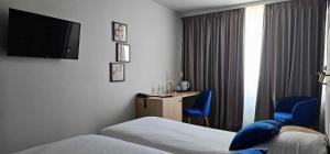 Voodi või voodid majutusasutuse Hotel Les 3 Cles toas