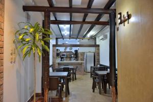 a dining room with tables and chairs and a mirror at Hotel La Barca in Atacames