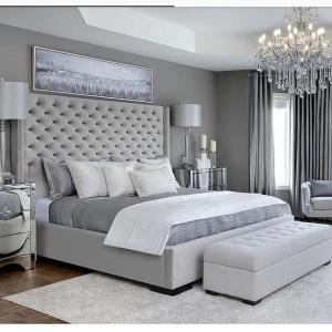 a large bedroom with a large bed and a chandelier at Booking cloning 12 in Pchelin