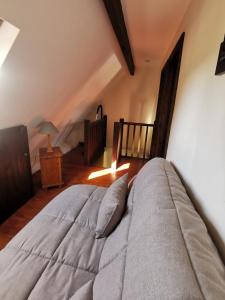 a bedroom with a large bed and a crib at Cottage du Marais in Bazinghen