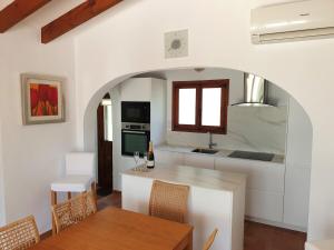 a kitchen and dining room with a table and chairs at Villa Casa Nuestra in Moraira