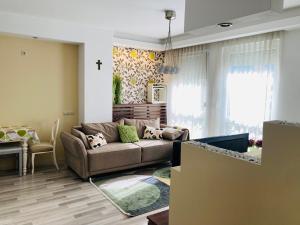 a living room with a couch and a table at Comfy Camel Apartment in Budapest