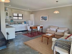 a living room with a couch and a table at Mill Cottages - Rosetta in Henburg Park