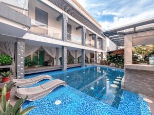 an exterior view of a building with a swimming pool at Eloisa Royal Suites in Mactan