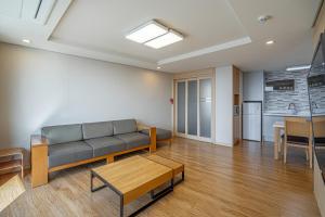 a living room with a couch and a table at Cheongpung Resort in Jecheon