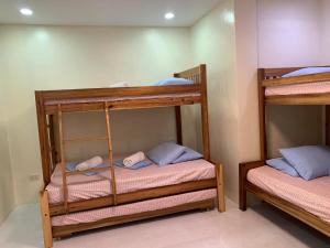 a room with two bunk beds in a room at Puerto Princesa City Palawan Harmony Inn in Puerto Princesa City