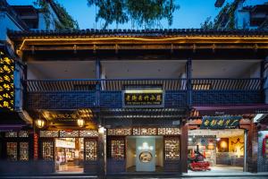 a building with chinese writing on the side of it at Old Street Yun Zhu Hotel in Huangshan