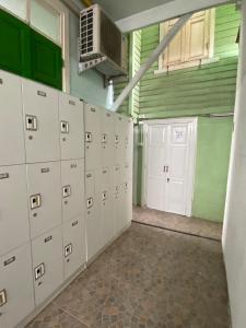 an empty garage with lockers and a fan in it at Green Garden Hostel in Bangkok