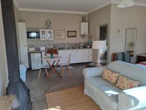 a living room with a couch and a table at Mill Cottages - Rosetta in Rosetta +14 photos