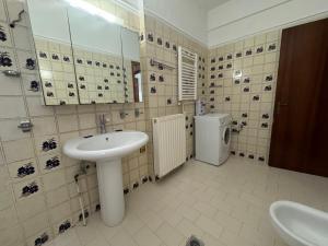 a bathroom with a sink and a washing machine at Villa Galini Ierissos in Ierissos +85 photos