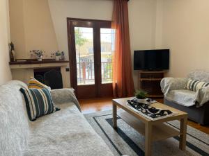a living room with a couch and a coffee table at Villa Galini Ierissos in Ierissos
