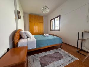 a bedroom with a bed and a table in it at Villa Galini Ierissos in Ierissos