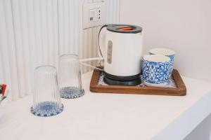 a coffee maker and two glasses on a counter at B&B L'Agapanto in Capri