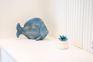 a statue of a fish sitting on a shelf next to a plant at B&B L'Agapanto in Capri