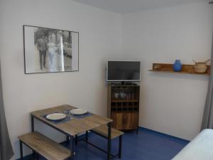 un salon avec une table et une télévision dans l'établissement Studio 27m2 centre-ville, à Bourges
