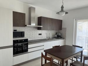 a kitchen with a table and a dining room at Casa Palma in Begliano