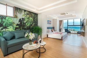 a living room with a couch and a bed at Areca Hotel Nha Trang in Nha Trang +69 photos
