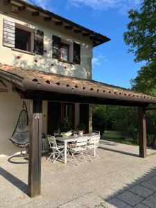 a patio with a table and chairs in front of a house at CaBicocca in San Zuanet