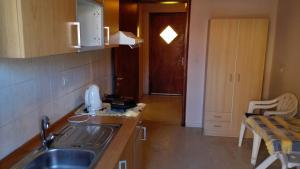 a kitchen with a sink and a counter top at Alexa Apartment in Corfu