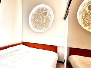 a room with a bed and two plates on the wall at Jais Home-Moon Apartment Old Town in Cluj-Napoca