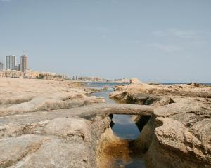 a body of water on a beach with rocks at The 501 by Shmoo in Sliema
