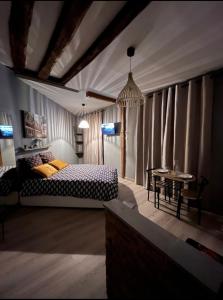 a bedroom with a bed and a table at Studio cosy, cité gastronomique in Dijon +3 photos