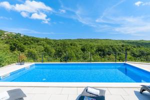 a swimming pool with a view of a mountain at Villa Manola by Briskva in Labin
