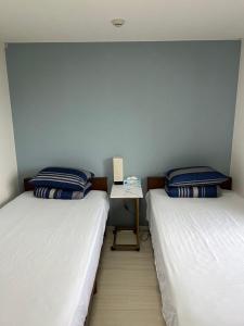 Una cama o camas en una habitación de 熱海温泉　実の別荘