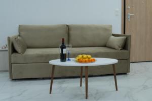 a table with a bottle of wine and a plate of fruit at Project Georgiadi #2 - Modern Apartment in peaceful neighborhood - 15 mins from Loutra Pozar in Aridaia