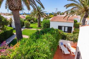 a view from the balcony of a villa with palm trees at Windrose in Son Xoriguer
