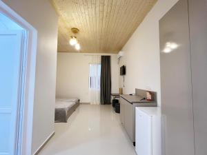 a bedroom with a bed and a desk in a room at Гостевой дом Руслан in Batumi