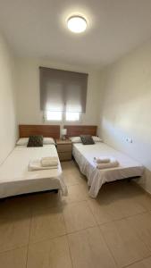 En eller flere senge i et værelse på Apartamento Tintín Moraira