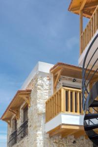 a building with wooden balconies on the side of it at Anassa Luxury Apartment 13 in Heraklio Town
