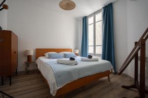 Ένα ή περισσότερα κρεβάτια σε δωμάτιο στο Le Duplex