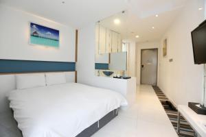 Postel nebo postele na pokoji v ubytování Hamdeok Beach Stay Jeju