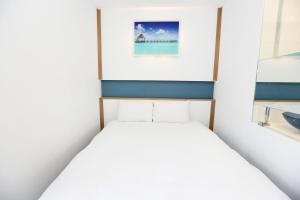 Postel nebo postele na pokoji v ubytování Hamdeok Beach Stay Jeju