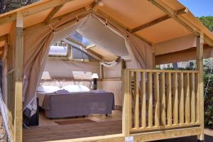 a gazebo with a bed on a deck at Costa D'Argento - Camping Village Club Capalbio in Capalbio +241 photos