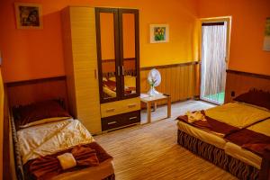 a bedroom with two beds and a desk with a mirror at Vakáció Üdülő in Révfülöp +44 photos
