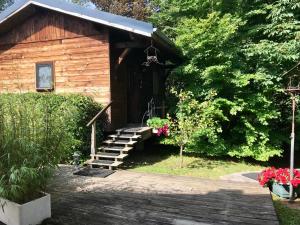 a log cabin with stairs leading to a door at Gîte Le Mazot de Vouan in Saint-André-de-Boëge