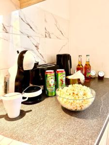a kitchen counter with a bowl of popcorn and soda at Final 1room Condo WarszawaCenter in Warsaw
