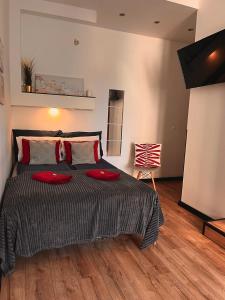 a bedroom with a bed with red pillows on it at Final 1room Condo WarszawaCenter in Warsaw
