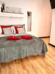 a bedroom with a bed with red pillows on it at Final 1room Condo WarszawaCenter in Warsaw +37 photos