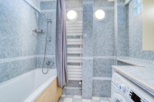a bathroom with a shower and a tub and a sink at Cette Maison est la Vôtre in Suresnes +4 photos