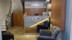 a waiting room with blue chairs and a counter at Galata Moon Hotel in Istanbul