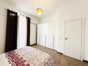 a bedroom with white cabinets and a large bed at Billy Home in Villabate