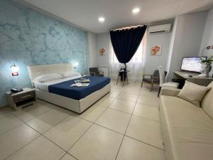 Postel nebo postele na pokoji v ubytování Mg Palace Hotel Costa del Sole