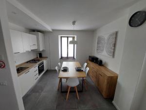 a kitchen with a table and chairs in a room at Cascina Rio Molini in Pieve Di Ledro
